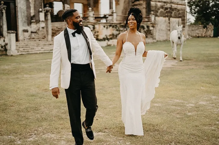 bride and groom holding hands after wedding reception