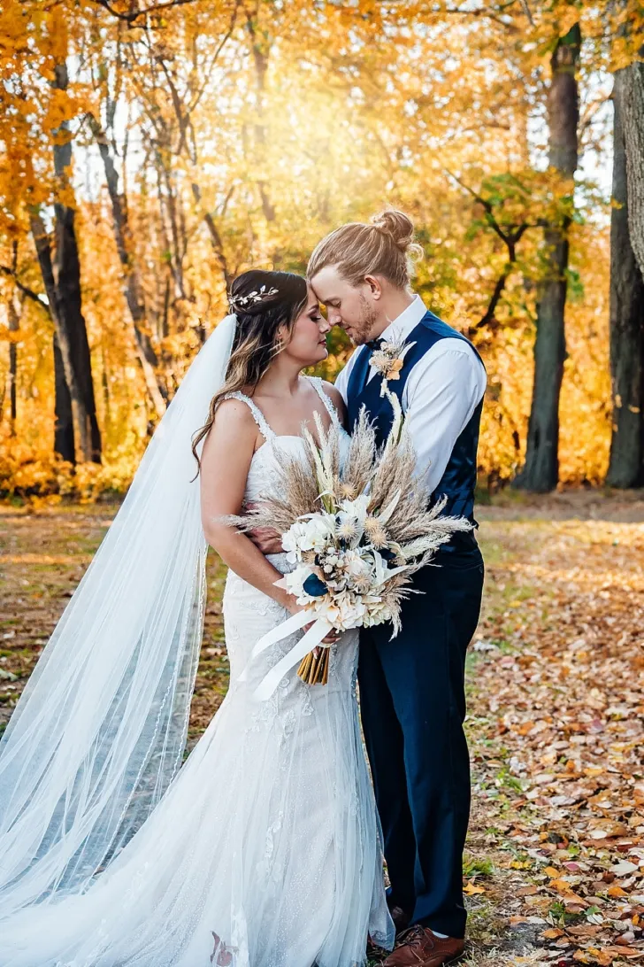 bride and groom embracing and smiling at each other